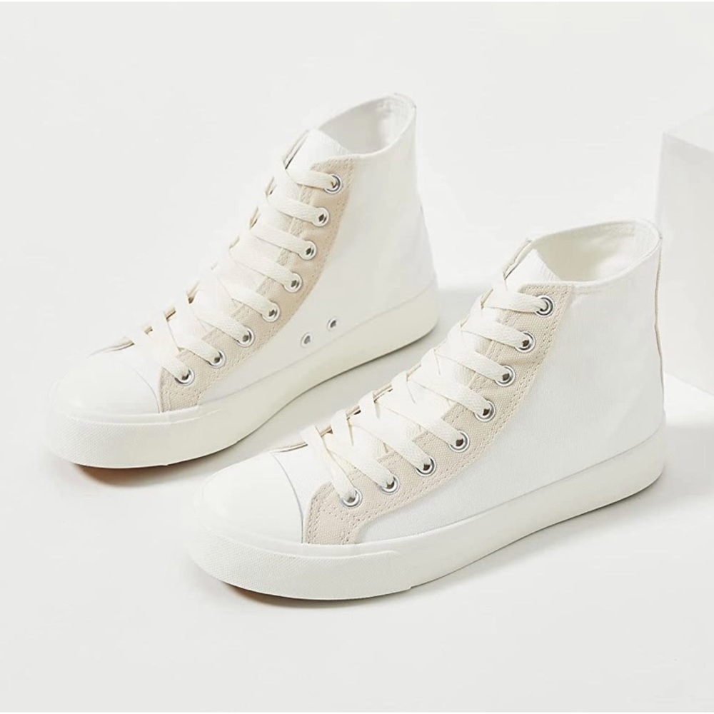White canvas shoes with tan accents